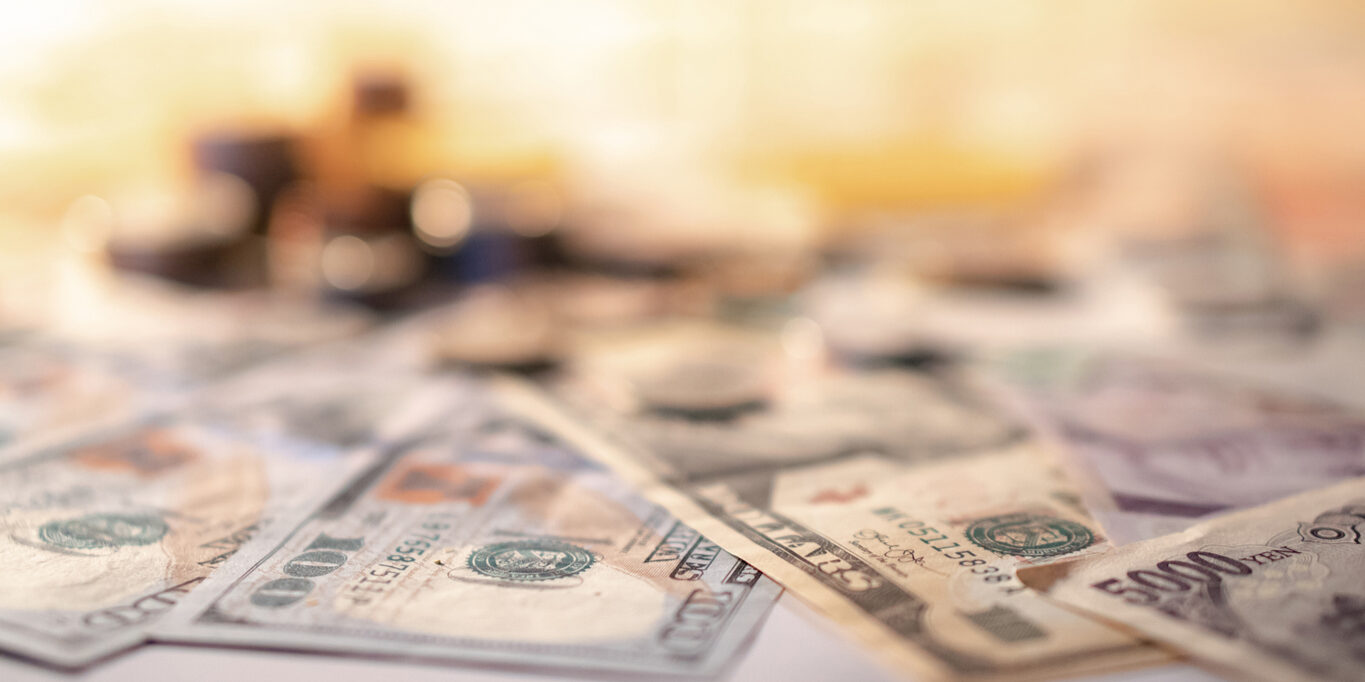 Various of international money coin and banknote background. Time investment with currency exchange concept. Focus on dollar banknote.