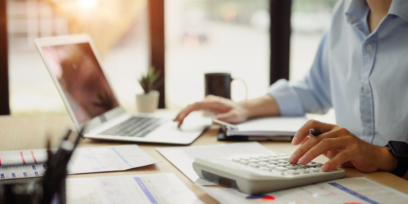 Businessman calculating finances at office desk. Concepts of finance management.