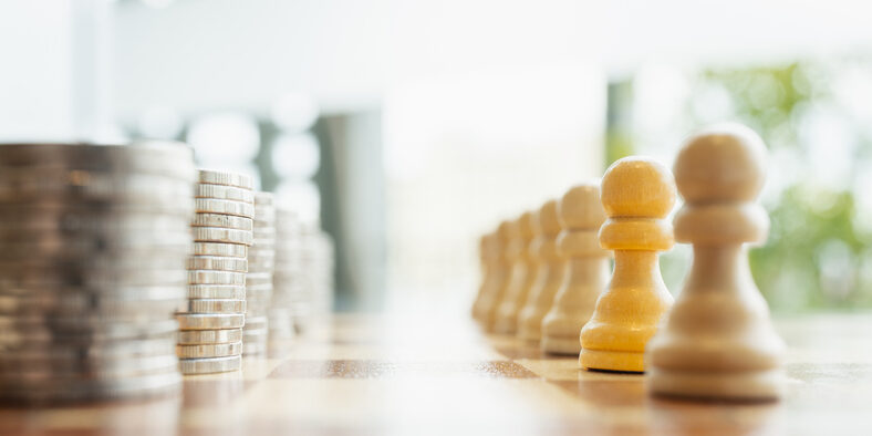 Symbolic image of stacked coins facing wooden chess pawns on a chessboard. Concept of economic power, financial strategy, workforce value, money dominance, inequality, and business planning.