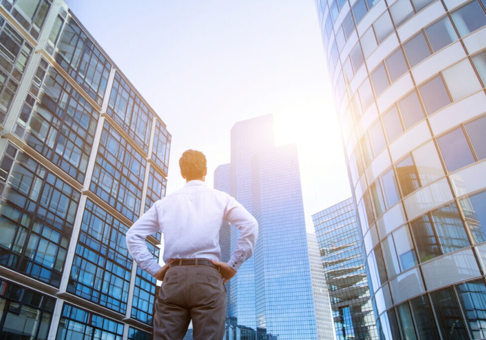 career concept, business background, man looking at office buildings