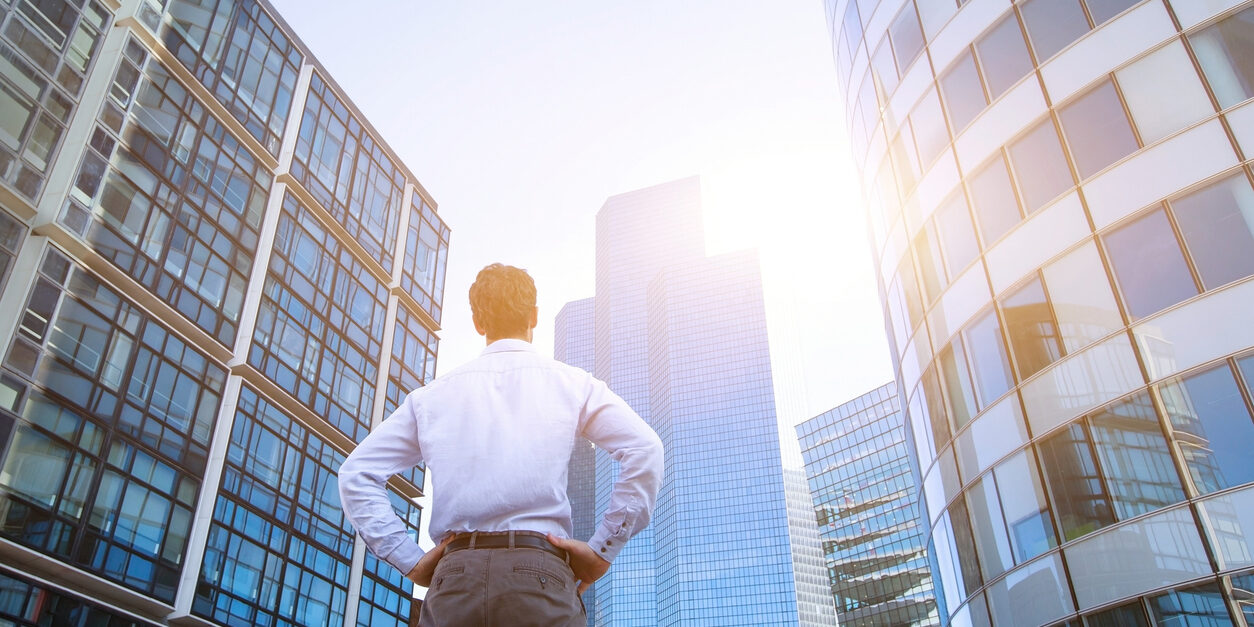 career concept, business background, man looking at office buildings